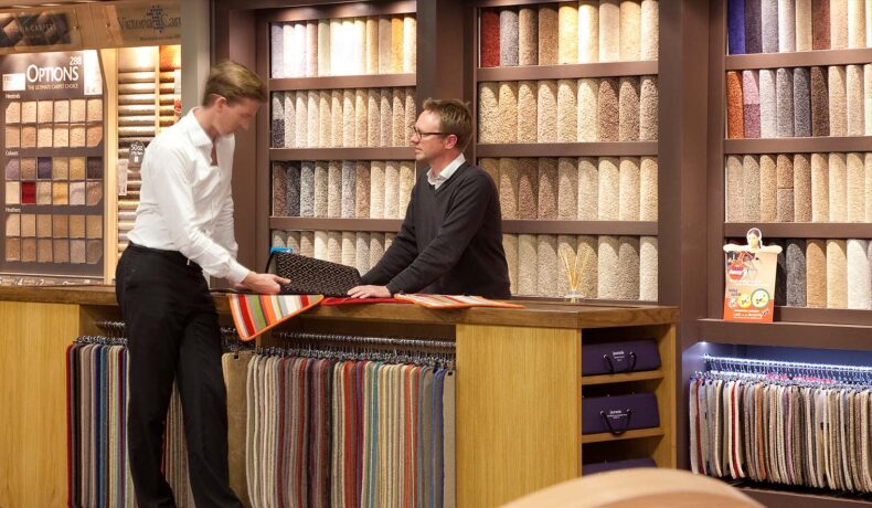 Two men looking at carpet in a carpet shop