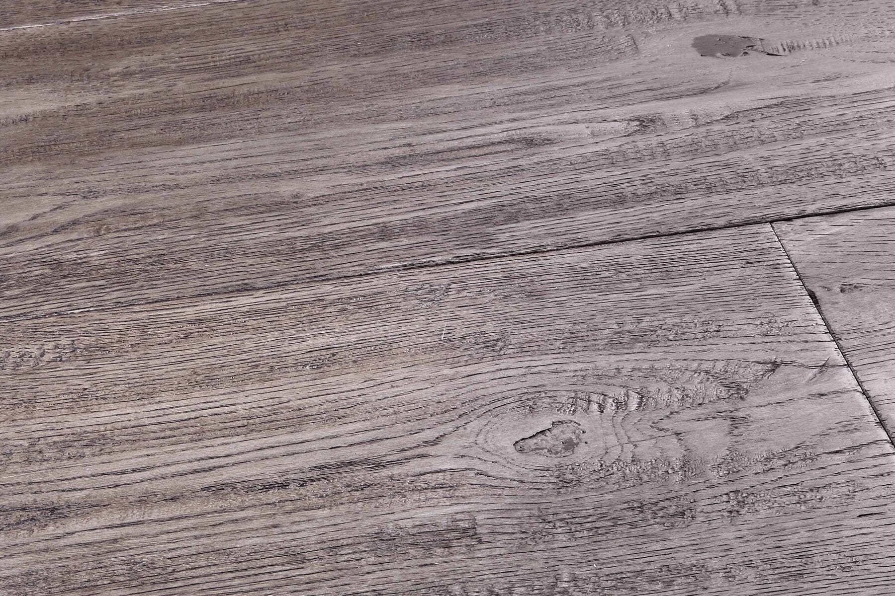 Grey engineered wood flooring of handscraped rustic distressed oak similar to a reclaimed board with natural oil finish in Surrey
