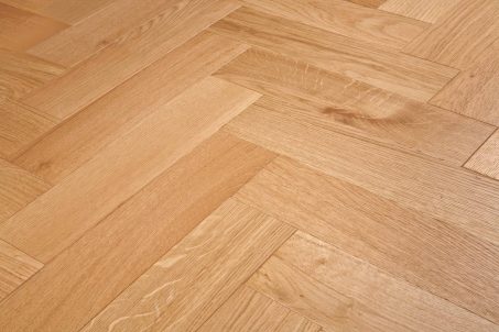 Light brown engineered wood flooring oak parquet herringbone with brushed surface finished with lacquer in Surrey
