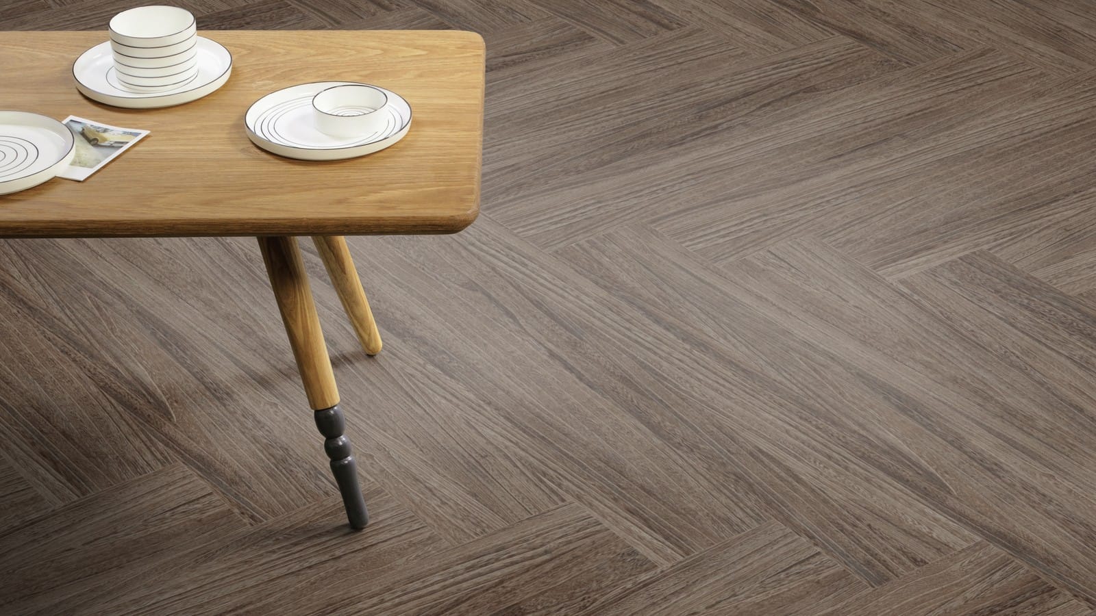 The Herringbone Plank design of Quill Sable luxury vinyl tile by Amtico