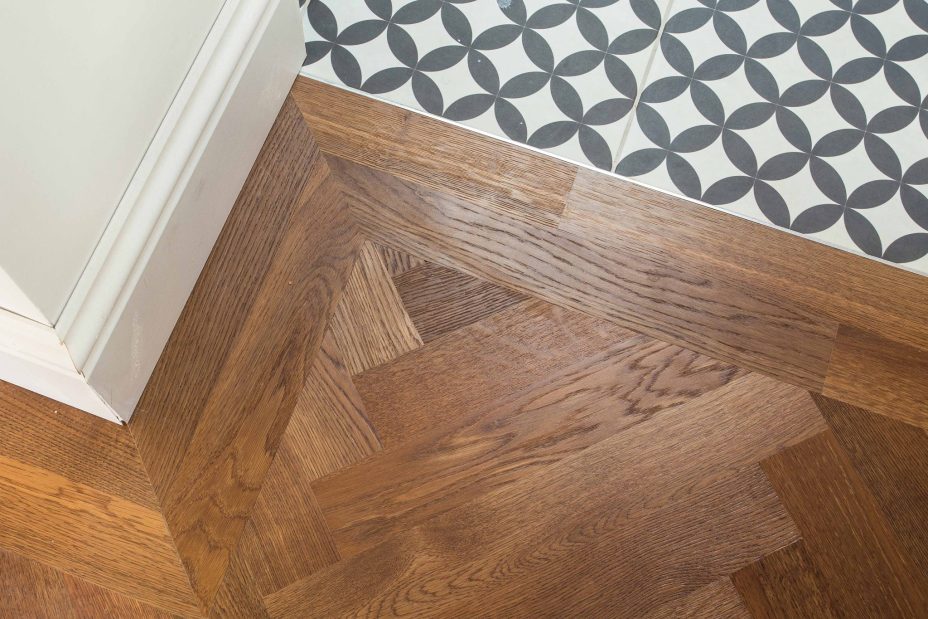 Brown engineered parquet wood flooring herringbone select oak finished with lacquer in Surrey
