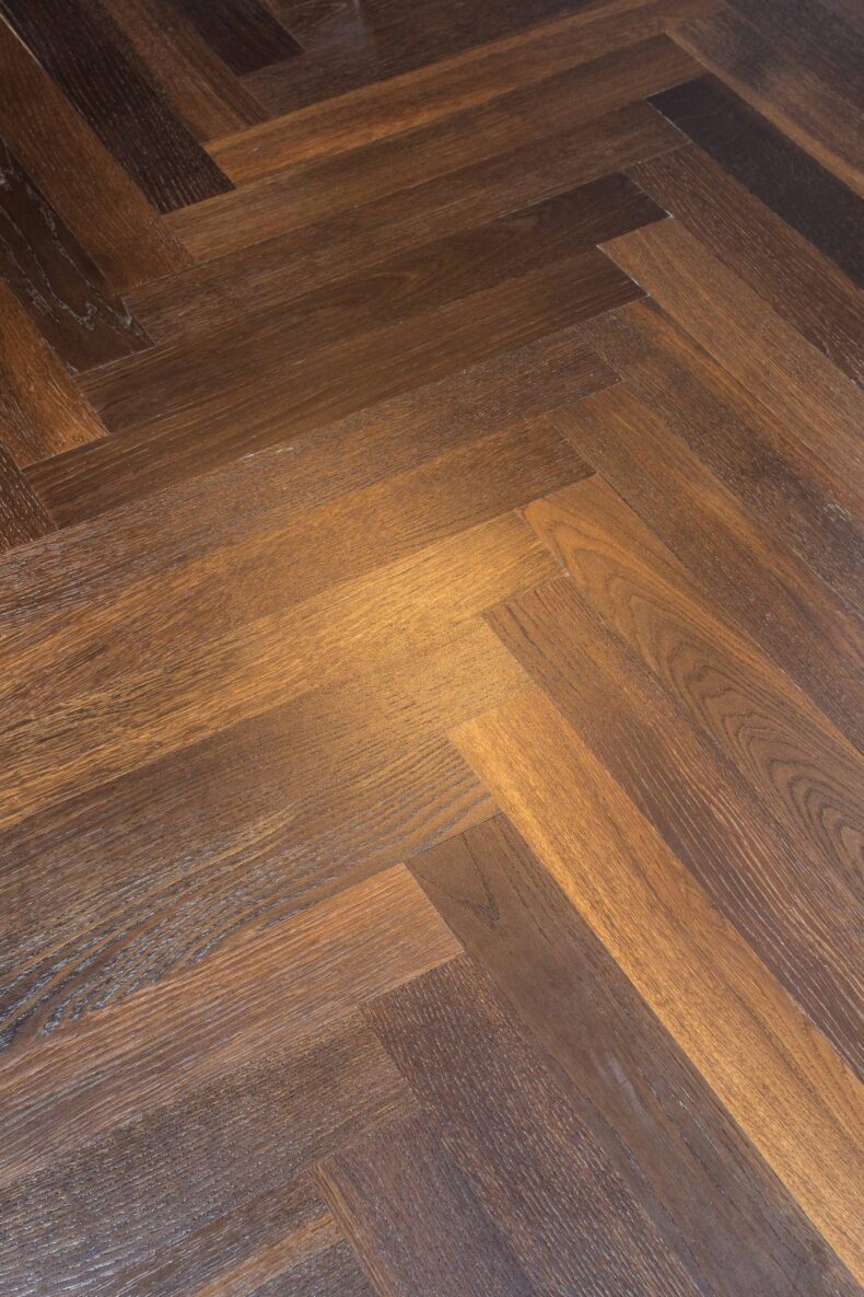 Dark brown engineered parquet wood flooring herringbone select oak finished with lacquer in Surrey
