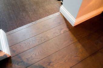 Dark brown engineered oak wood flooring classic grade in three widths 140mm 180mm 220mm wide fumed and finished with natural dark oil in Surrey