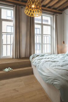View of Elegant Oak Fumed AVMPU40317 luxury vinyl tile by Quick-Step Livyn