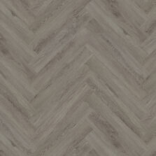 View of Flint Grey 5076201 (Universal 55 Herringbone) luxury vinyl tile by Victoria Design Floors