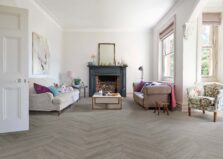 View of Flint Grey 5076201 (Universal 55 Herringbone) luxury vinyl tile by Victoria Design Floors