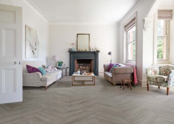 View of Flint Grey 5076201 (Universal 55 Herringbone) luxury vinyl tile by Victoria Design Floors