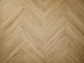 View of Sandy Oak (Herringbone) luxury vinyl tile by Elements Inspirations
