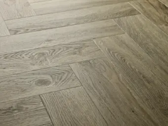 View of Dove Oak (Herringbone) luxury vinyl tile by Elements Inspirations