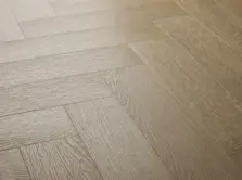 View of Blonde Oak (Herringbone) luxury vinyl tile by Textures LVT