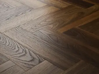 View of Warm Walnut (Herringbone) luxury vinyl tile by Textures LVT
