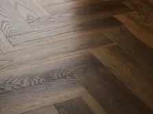 View of Warm Walnut (Herringbone) luxury vinyl tile by Textures LVT