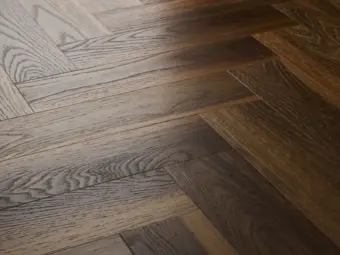 View of Warm Walnut (Herringbone) luxury vinyl tile by Textures LVT